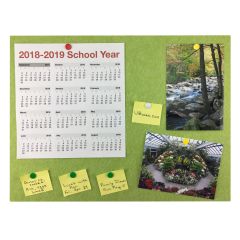 green bulletin board with calendar, picture, and written notes
